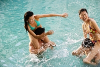 Couples in swimming pool, women sitting on men's shoulders - Jade Lee