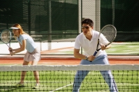 Couple playing a game of mixed doubles tennis - Alex Microstock02