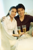 Couple looking at camera, champagne glasses in front of them - Alex Microstock02