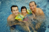 Father, grandfather and young girl in a swimming pool, looking at camera - Alex Microstock02