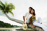 Couple sitting on tree, looking away - Jade Lee