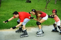 Family wearing roller blades, all in a row - Jade Lee