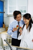 Couple in kitchen holding champagne - Jade Lee