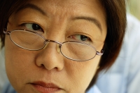 Woman with glasses, looking away, headshot - Jade Lee