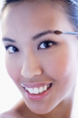 Headshot of woman using make-up brush - Alex Microstock02