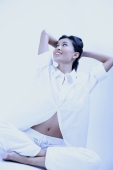 Woman in white shirt and pants, legs crossed, hands behind head - Alex Microstock02