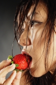 Young woman with wet hair, eating a strawberry - Alex Microstock02