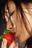 Young woman with wet hair, kissing a strawberry - Alex Microstock02