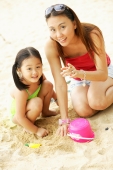 Mother with one child on beach, looking at camera - Alex Microstock02