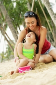 Mother with daughter on beach, laughing, portrait - Alex Microstock02