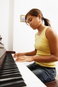 Young woman playing the piano, at home - Alex Microstock02