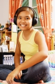 Young woman wearing headphones, looking at camera - Alex Microstock02
