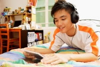 Young man listening to music, smiling - Alex Microstock02