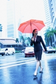 Business woman with umbrella, crossing the road - Alex Microstock02
