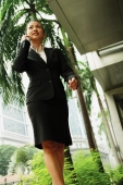 Business woman using mobile phone, low angle view - Alex Microstock02