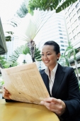 Business woman reading newspaper - Alex Microstock02