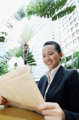 Business woman holding newspaper, smiling - Alex Microstock02
