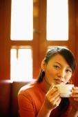 Young woman with teacup, looking at camera - Alex Microstock02