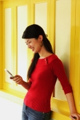 Young woman using mobile phone, text messaging - Alex Microstock02