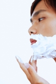 Young man with shaving foam on face, sideview - Alex Microstock02