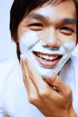 Young man applying shaving foam on face - Alex Microstock02