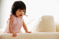 Baby girl leaning on sofa, portrait - Alex Microstock02