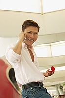 Man holding ring box, using mobile phone, looking away - Alex Microstock02