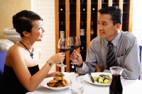 Couple dining out, raising wine glass for a toast - Alex Microstock02