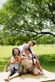 Family with two children, children climbing on father - Alex Microstock02