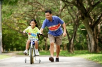 Girl cycling, father running behind her - Alex Microstock02