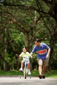 Girl cycling, father running next to her - Alex Microstock02