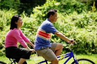 Couple cycling on tandem bicycle - Alex Microstock02