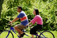 Couple in park, riding tandem bicycle - Alex Microstock02