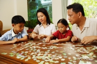  Family playing with jigsaw puzzle, indoor - Alex Microstock02