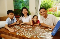  Family in living room, jigsaw puzzle on table - Alex Microstock02