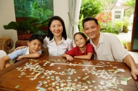  Family in living room, jigsaw puzzle on table, portrait - Alex Microstock02