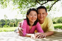 Couple on picnic mat, looking at camera - Alex Microstock02