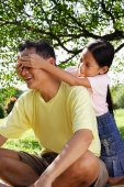 Daughter covering father's eyes with her hands - Alex Microstock02
