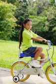 Young girl on bicycle, looking at camera - Alex Microstock02