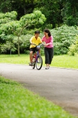 Mother guiding son on bicycle - Alex Microstock02