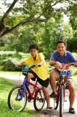 Father and son on bicycle, looking at camera - Alex Microstock02