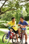 Father and son on bicycle, looking at each other - Alex Microstock02