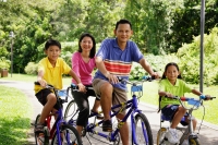 Family on bicycles, looking at camera - Alex Microstock02