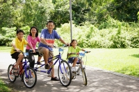 Family with two children, on bicycles, looking at camera - Alex Microstock02