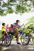 Family, on bicycles, giving each other high fives - Alex Microstock02