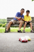 Father and son playing with remote control cars - Alex Microstock02