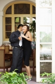 Couple at doorway, woman laughing - Alex Microstock02