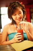 Young woman holding drink with straw - Alex Microstock02