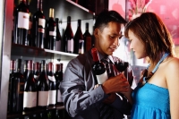 Couple standing face to face, man holding wine glass - Alex Microstock02