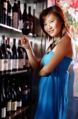 Young woman holding wine glass, looking at camera - Alex Microstock02